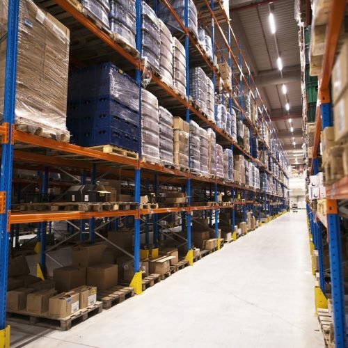 interior-large-distribution-warehouse-with-shelves-stacked-with-palettes-goods-ready-market